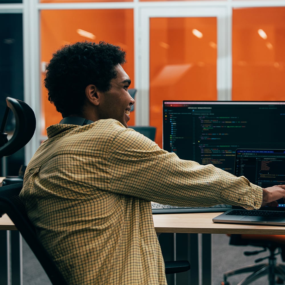 Shopify developer working on custom ecommerce store build at computer