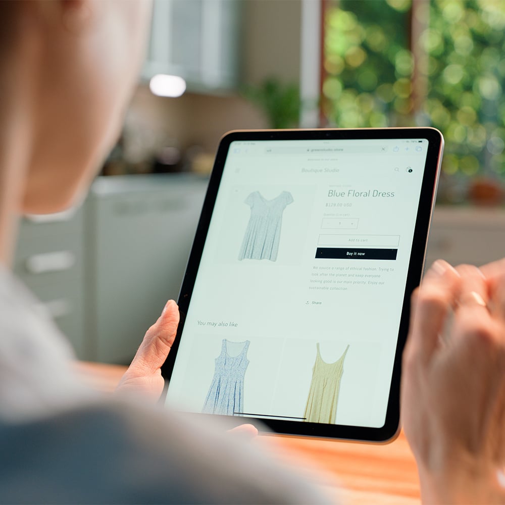 Shopify user browsing product page on tablet for online clothing store