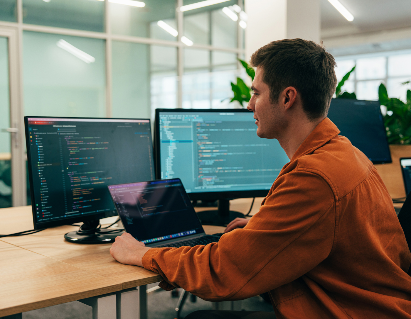 Shopify developer working on custom ecommerce store build at computer