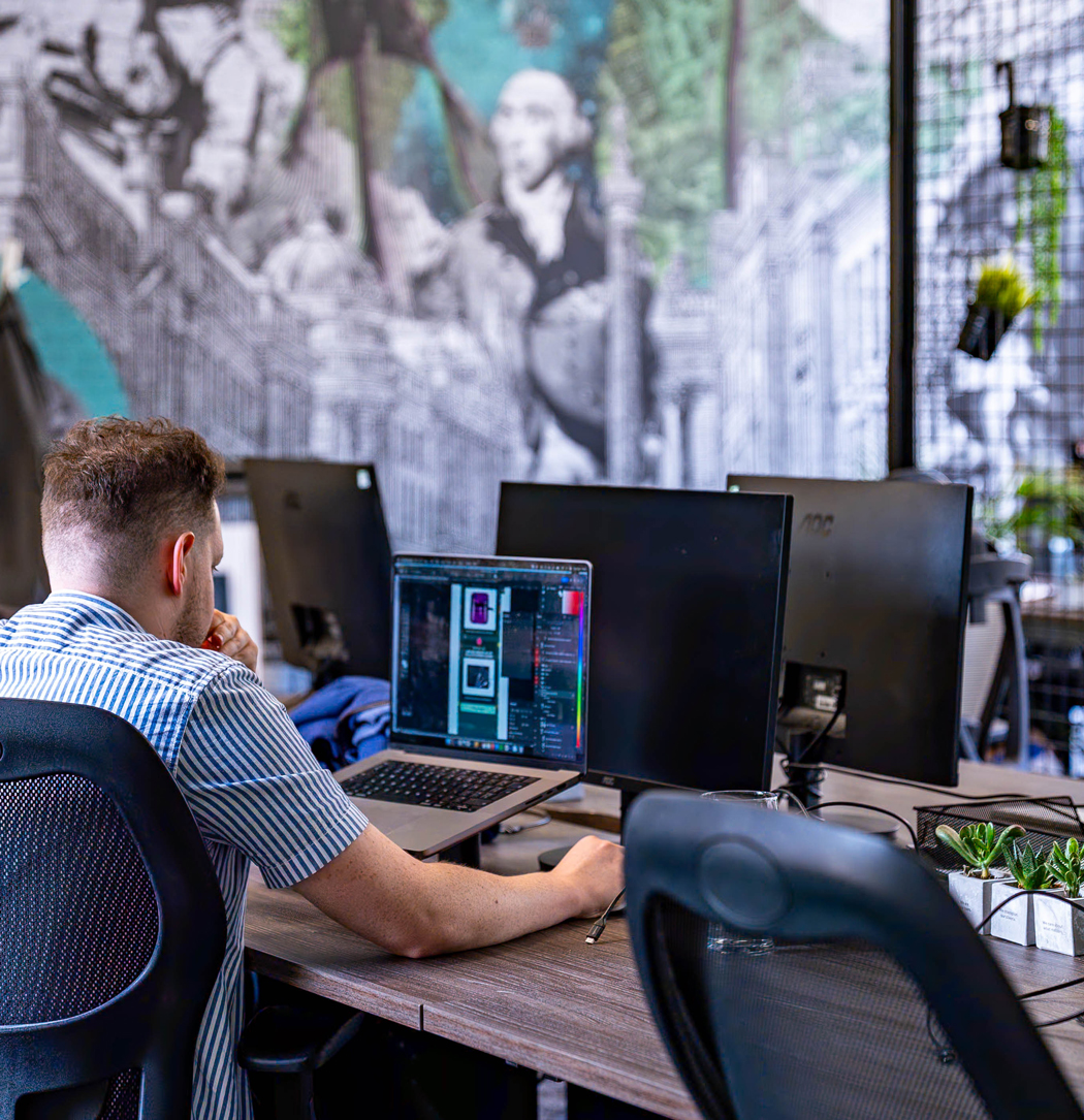 Visualsoft support specialist working on designs for a shopify storefront in our office.