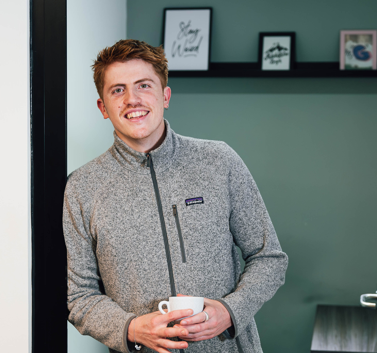 Our Visualsoft design team member holding a coffee in our head office